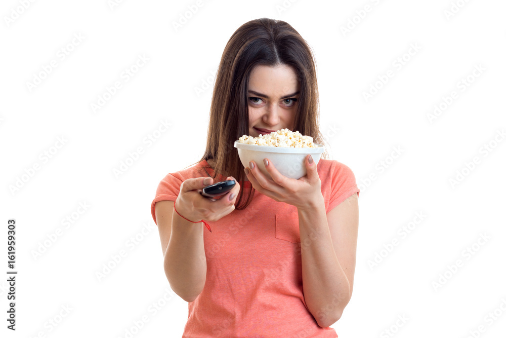 Pretty young girl eats pop-corn and watching tv Pretty young girl eats pop-corn and watching tv