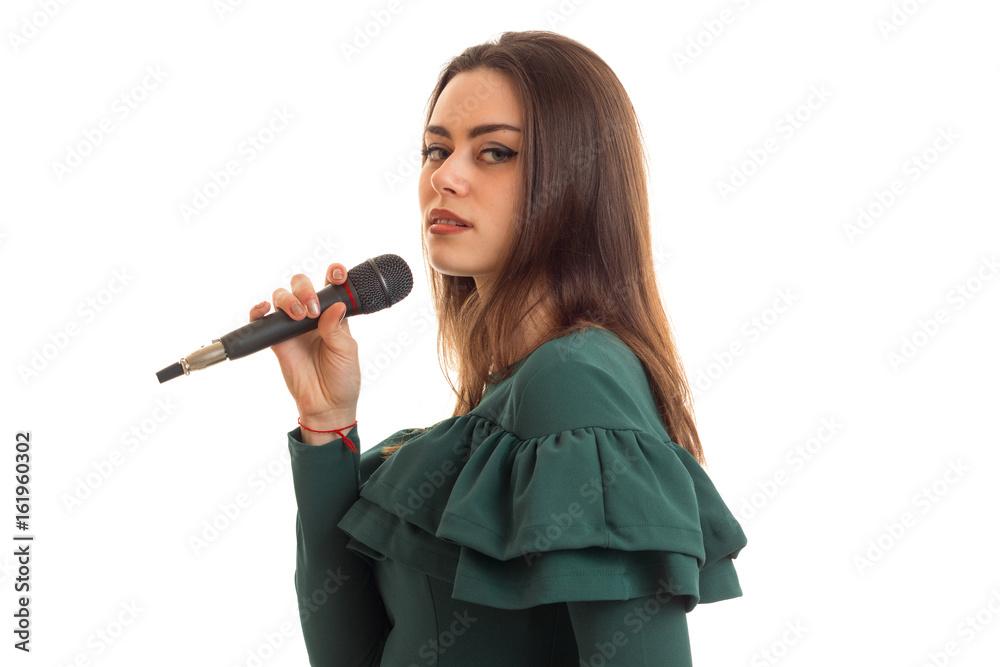 Serious young girl sings a karaoke in microphone Serious young girl sings a karaoke in microphone