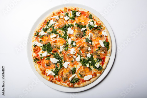 Italian delicious pizza with tomato, broccoli and cheese.