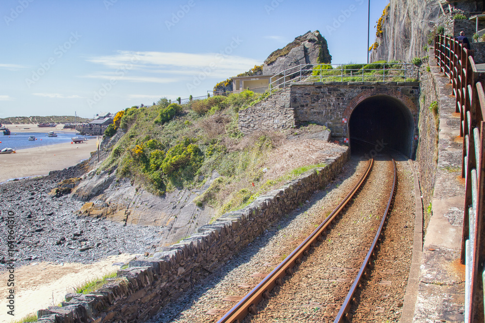 Naklejka premium Railway tunnel besides the beach in Barmouth, North Wales