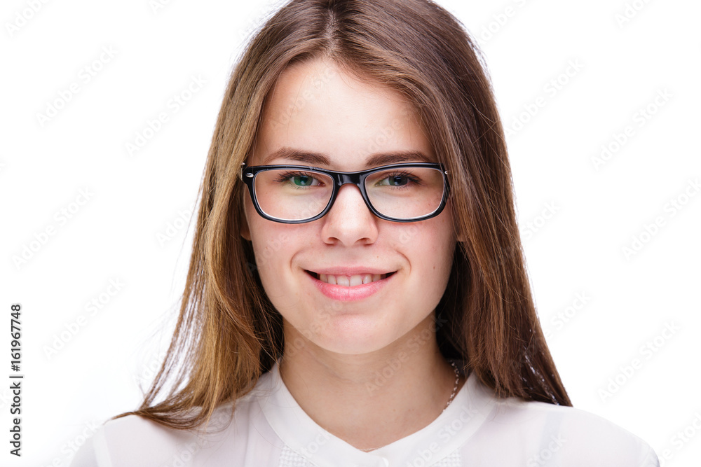 Beautiful young girl in glasses with a black rim a white shirt on an isolated background. Business concept