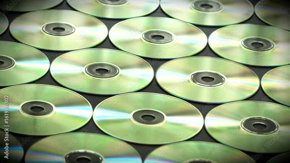 Neatly Arranged in Rows of cd or Dvds Disks on the Table Neatly Arranged in Rows of cd or Dvds Disks on the Table