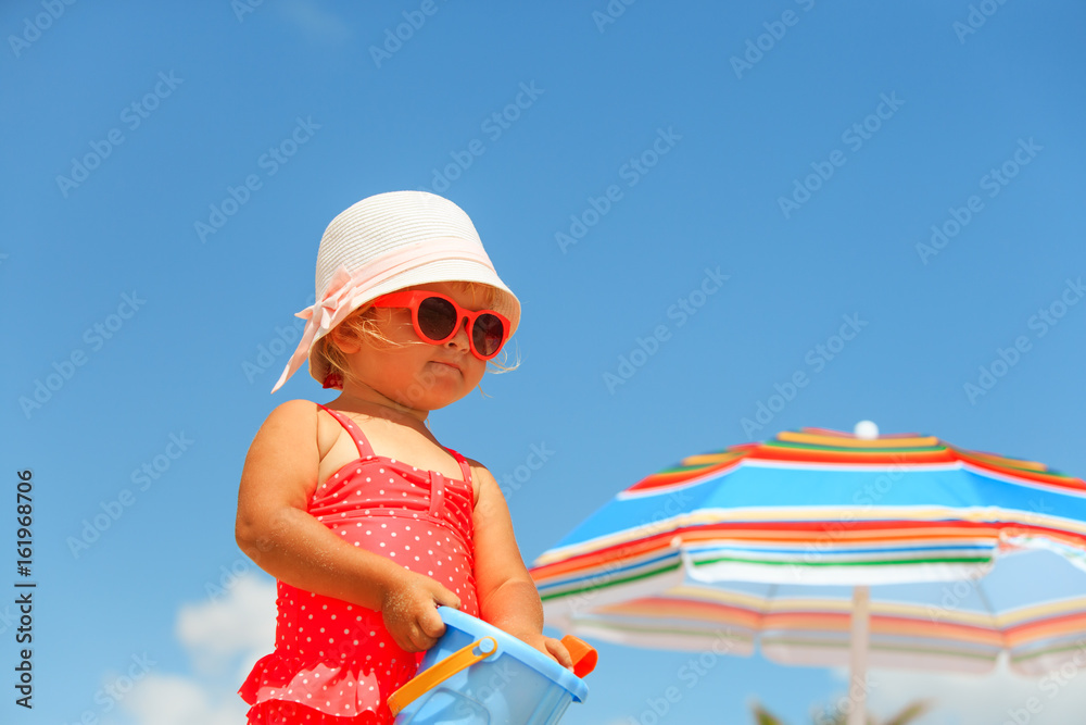 cute little girl play on summer beach