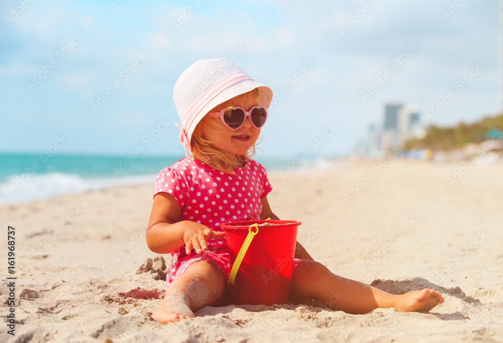 cute little girl play with sand on beach cute little girl play with sand on beach