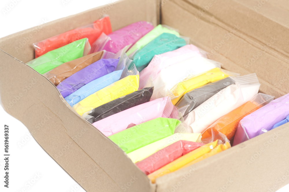Colorful polymer clay in box isolated on white Colorful polymer clay in box isolated on white