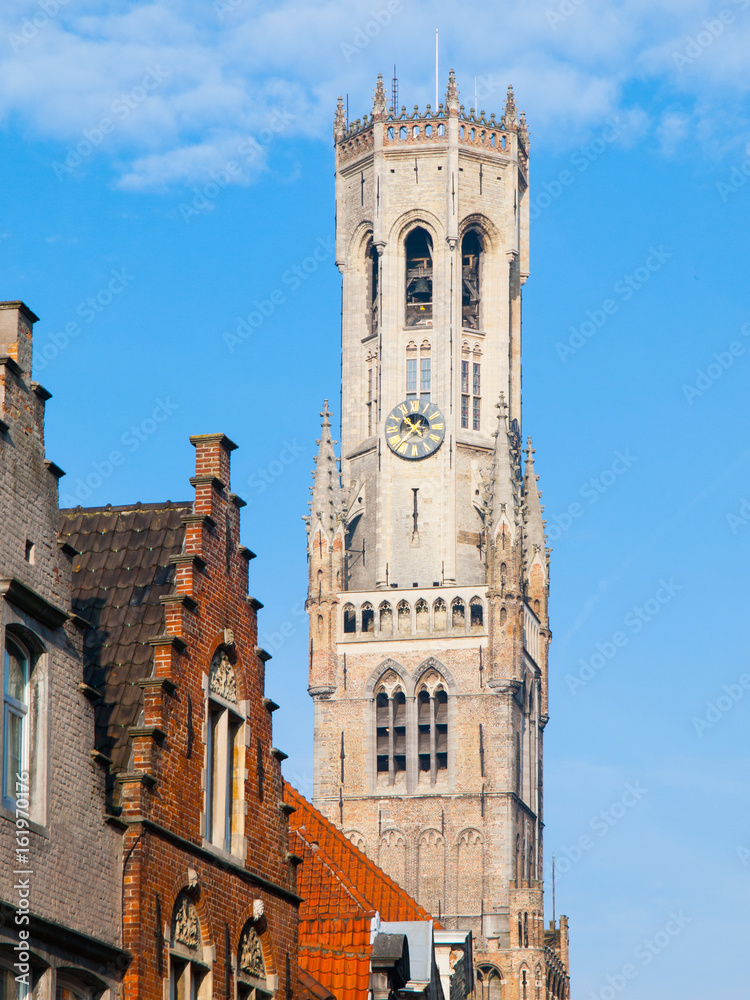 The Belfry Tower, aka Belfort, of Bruges, medieval bell tower in the historical centre of Bruges, Belgium. Close-up view of the top.