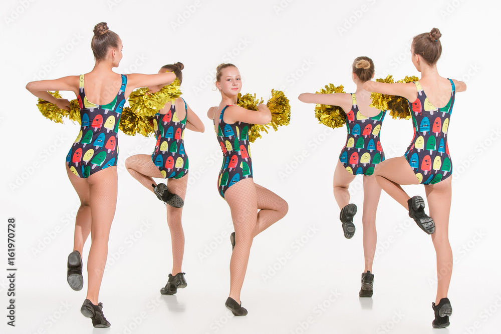 The group of teen cheerleaders posing at white studio The group of teen cheerleaders posing at white studio