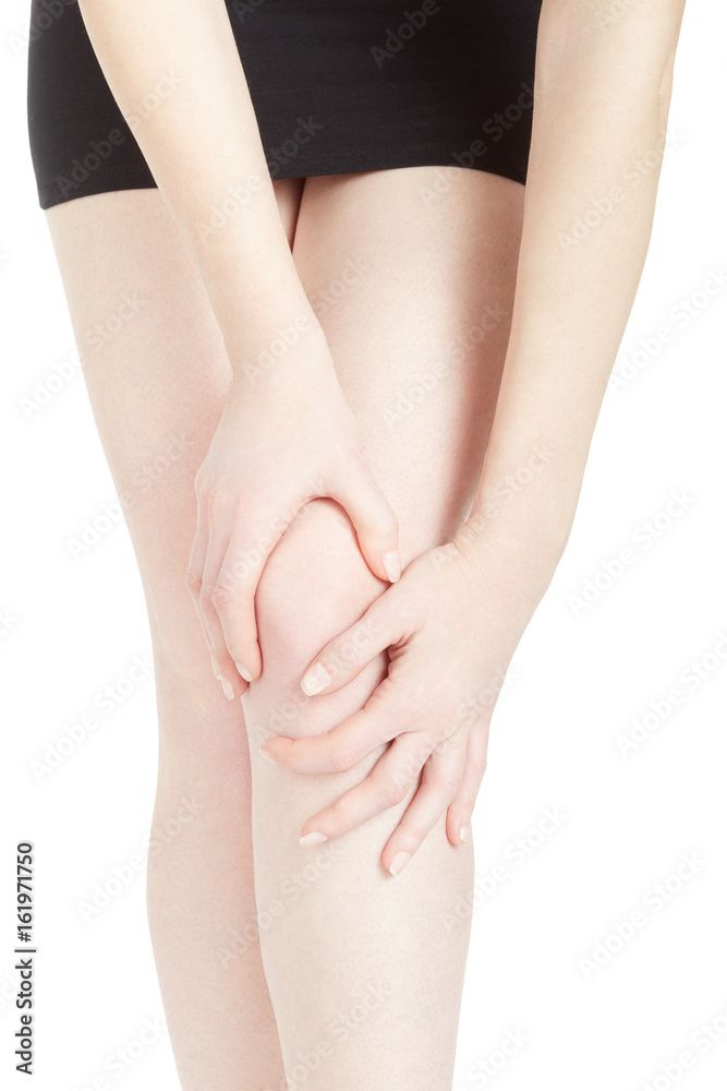 Young woman with black skirt suffering from knee pain isolated on white, clipping path Young woman with black skirt suffering from knee pain isolated on white, clipping path