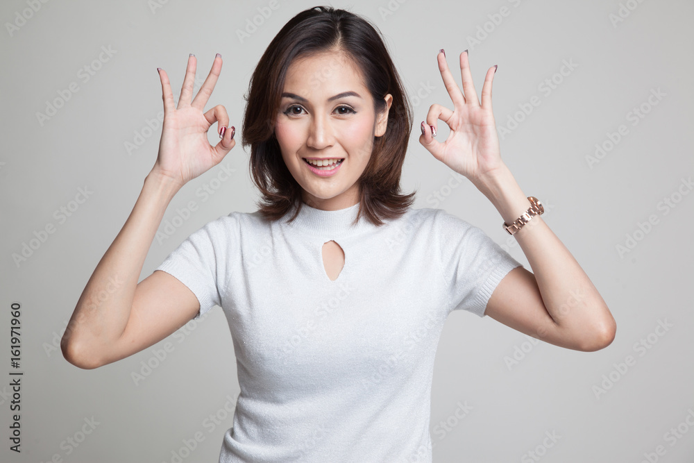 Asian woman show double OK hand sign and smile. Asian woman show double OK hand sign and smile.