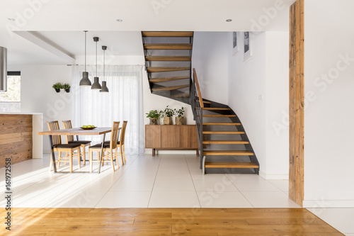 Half-landing stairs and wooden dining area