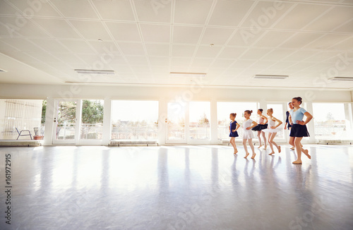 Fototapeta Naklejka Na Ścianę i Meble -  Group of children ballerinas practicing in ballet class
