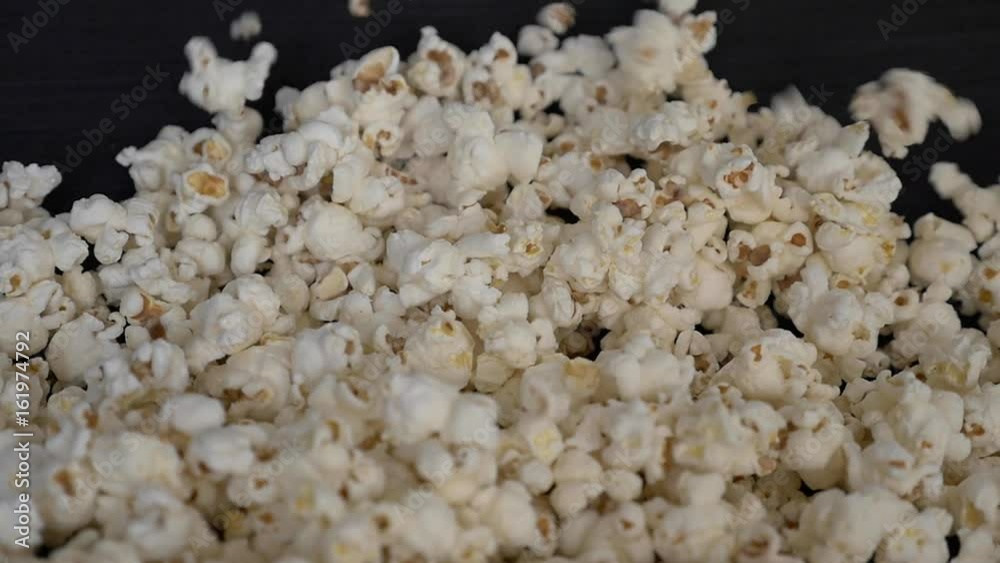 Frontal shot of popcorn falling in slow motion to a pile Frontal shot of popcorn falling in slow motion to a pile