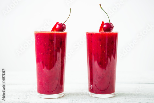 Wallpaper Mural Cherry smoothie and tasty berries on glass on white background. Fresh natural milkshake Torontodigital.ca