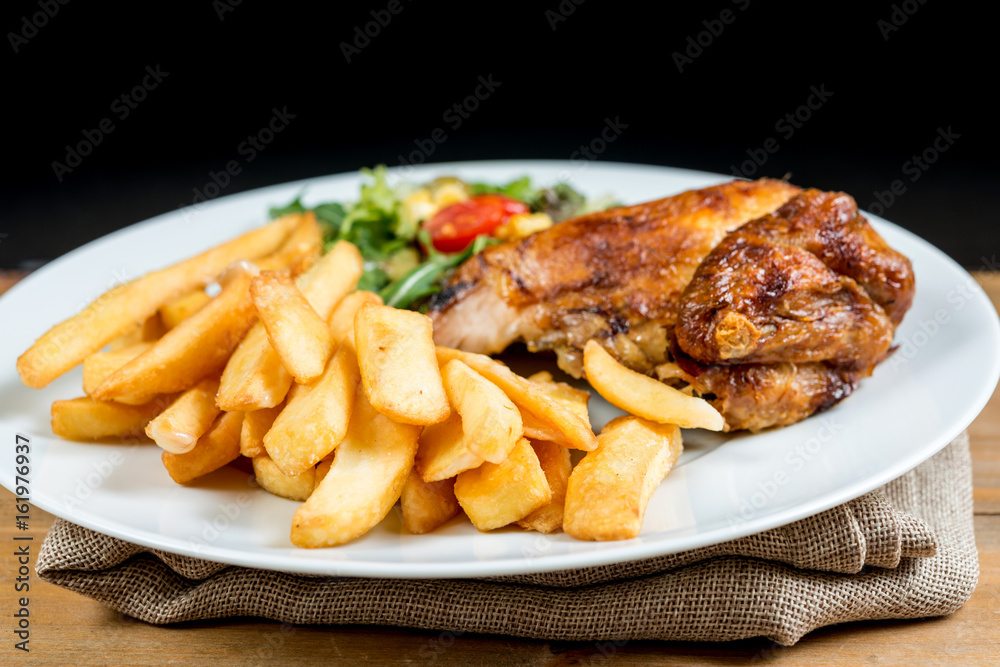Chicken with sauce and golden French fries potatoes Chicken with sauce and golden French fries potatoes