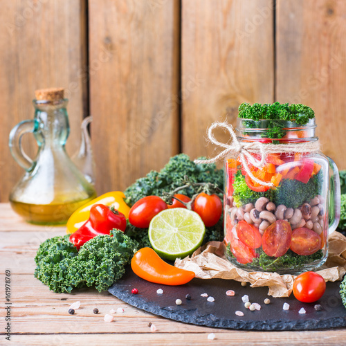 Fototapeta Naklejka Na Ścianę i Meble -  Healthy vegan salad in a mason jar with beans
