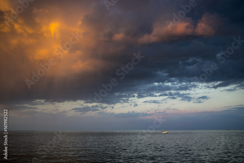 Sunset Reflecting off Storm Clouds over Water © Anji