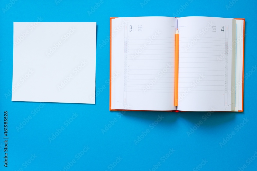 Top view blue desk table. Office tools on colored background. Flat lay of workspace