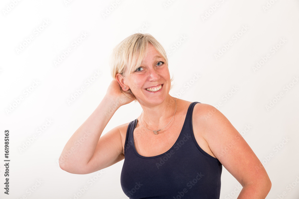 portrait of a attractive blond haired mid aged european woman wearing blue tank top showin happy face - half body - studio shot on white background. portrait of a attractive blond haired mid aged european woman wearing blue tank top showin happy face - half body - studio shot on white background.
