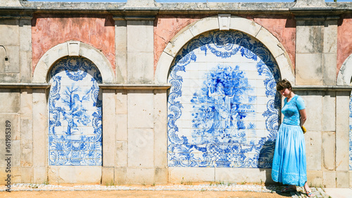 tourist near outside wall of Estoi Palace photo