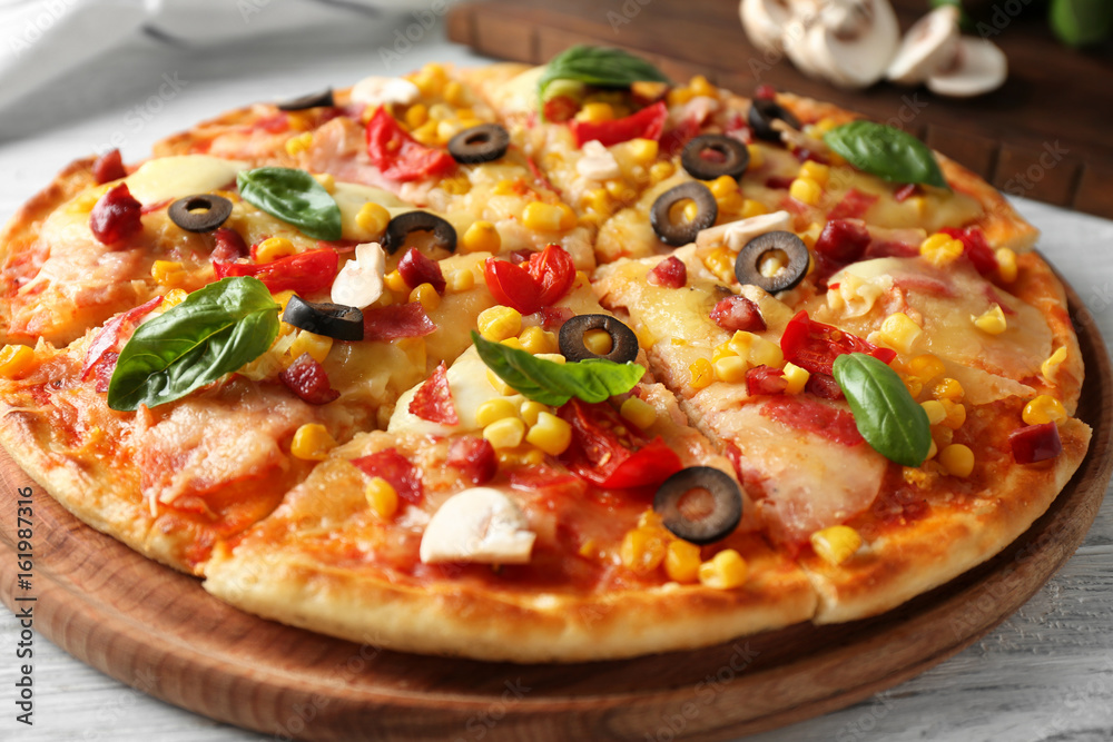 Plate with tasty pizza on wooden table