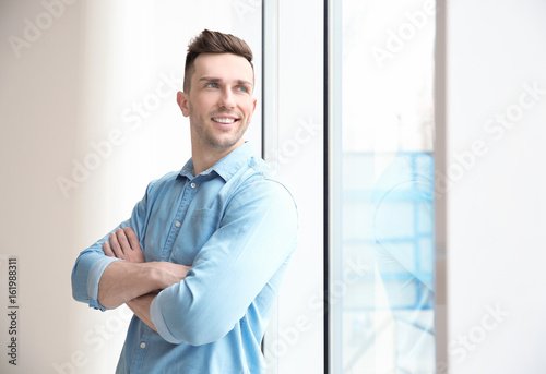 Smiling man standing near b...
