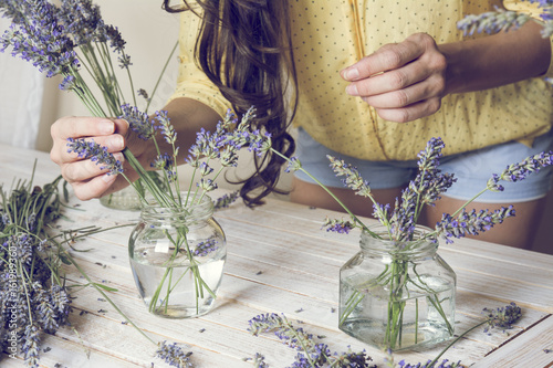 Fototapeta Naklejka Na Ścianę i Meble -  Florist at work: Creating small bouquets of natural lavender flowers