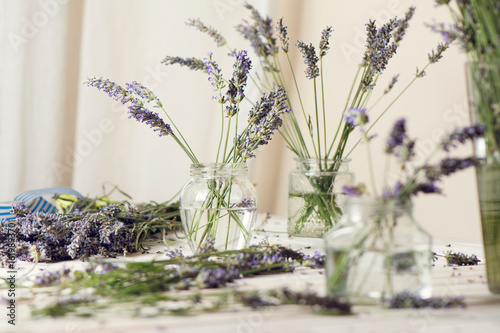 Fototapeta Naklejka Na Ścianę i Meble -  Small bouquet of fresh lavender in jars with water