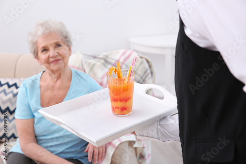 Young man serving glass of ...