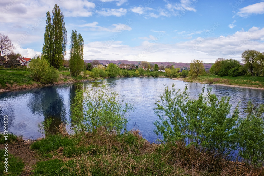 Beautiful countryside landscape with river in spring