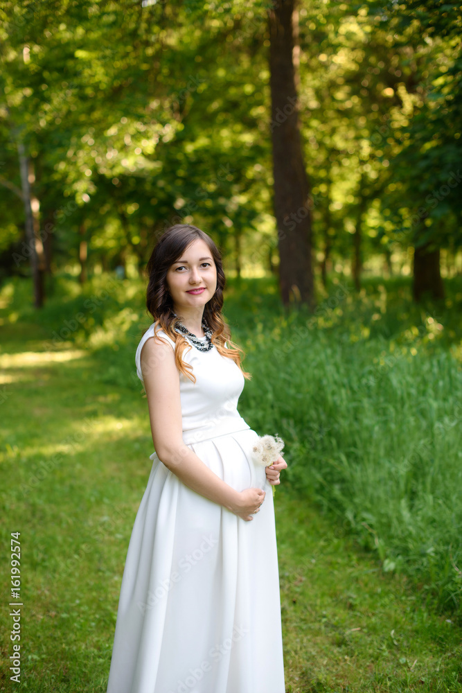 Outdoor portrait of young pregnant woman in summer nature Outdoor portrait of young pregnant woman in summer nature