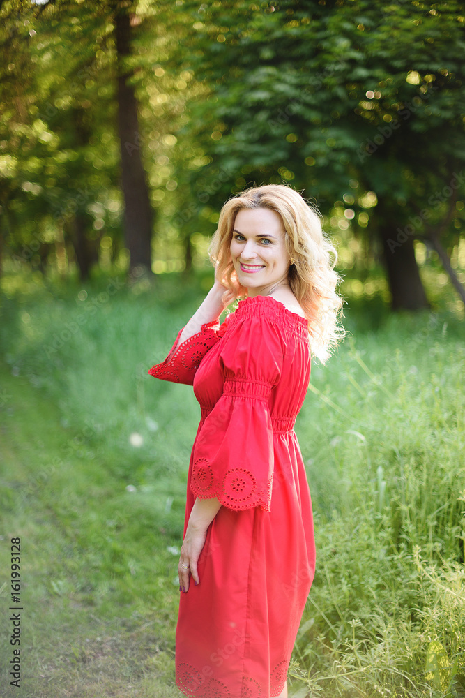 Beautiful blonde woman wearing red dress 