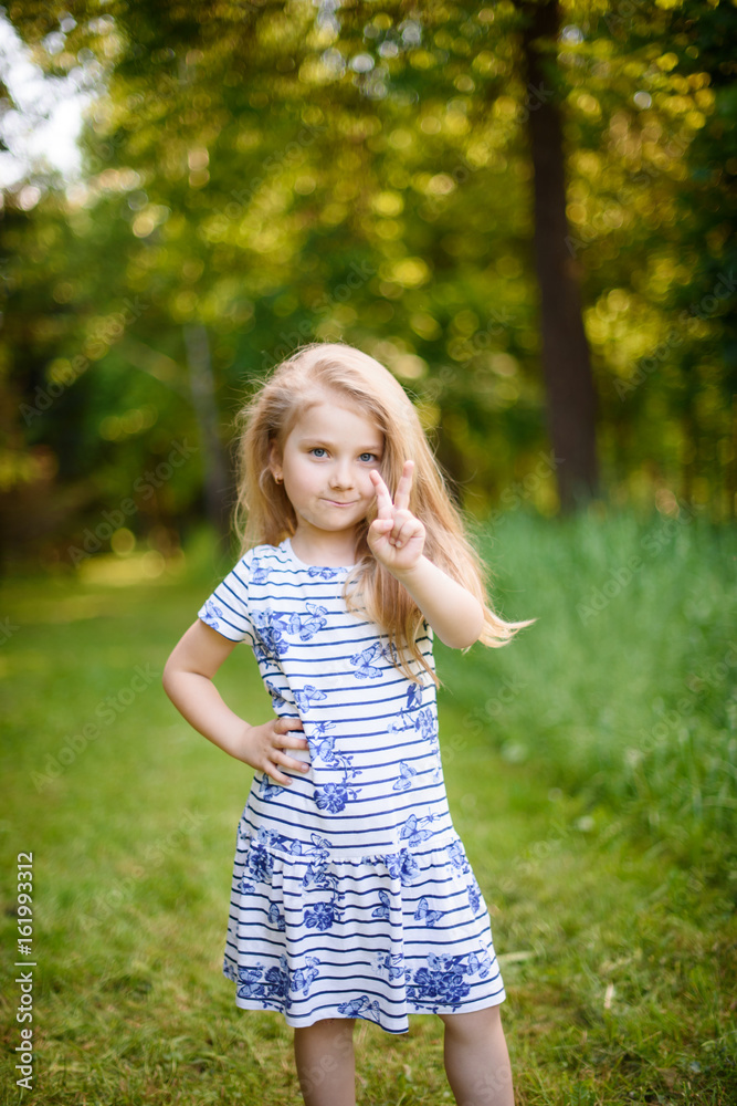 Portrait of a blonde girl outdoors in the park Portrait of a blonde girl outdoors in the park