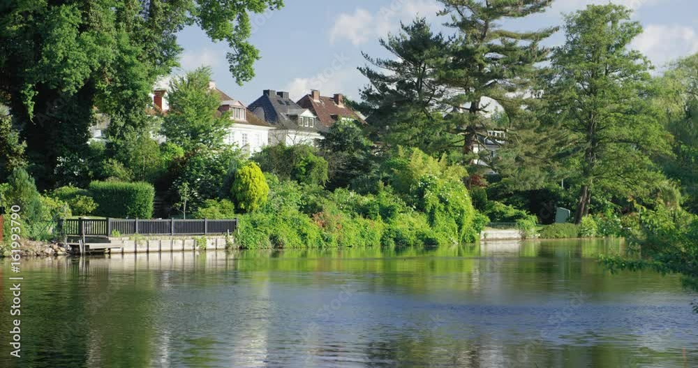 View of beautiful white villas located near river View of beautiful white villas located near river