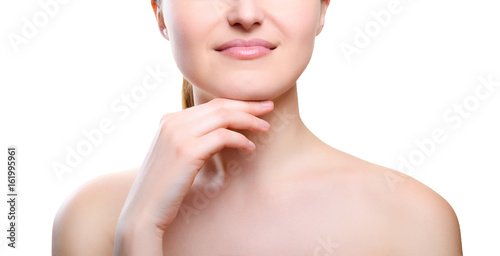 Portrait of girl with nude make-up with hands on chin isolated on white background. Girl with clean healthy skin on white. Cosmetology, medicine, beauty care. Nude makeup