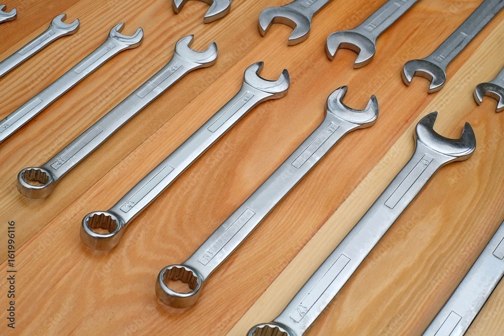 Various wrenches on a wooden board Various wrenches on a wooden board