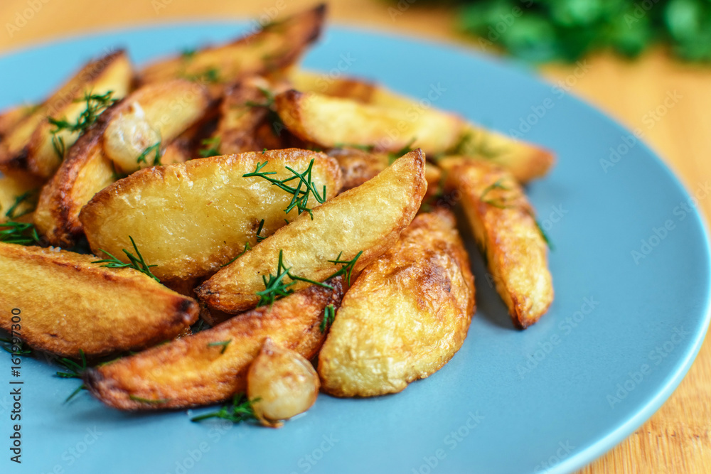 Roasted potatoes with salt pepper and cumin on wooden background Roasted potatoes with salt pepper and cumin on wooden background