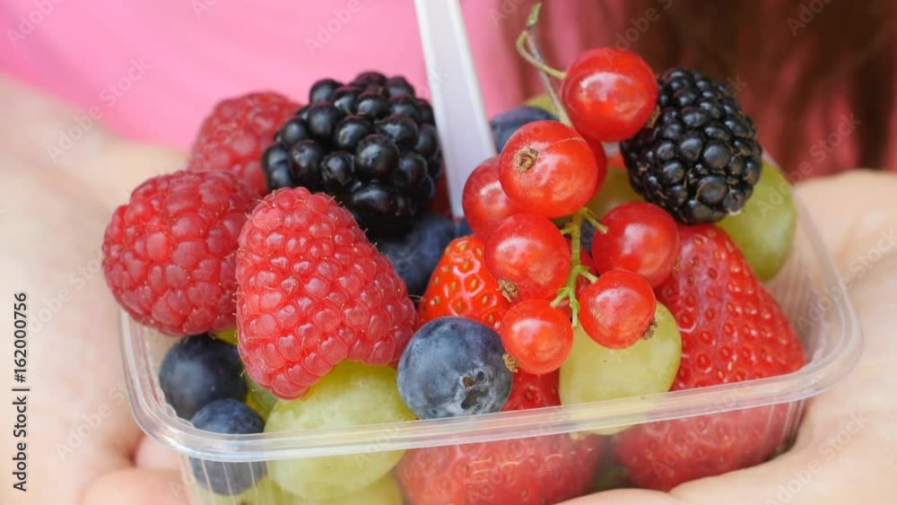Woman holding berries and fruit in hands