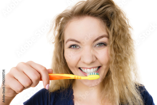 Happy positive woman brushing teeth, isolated