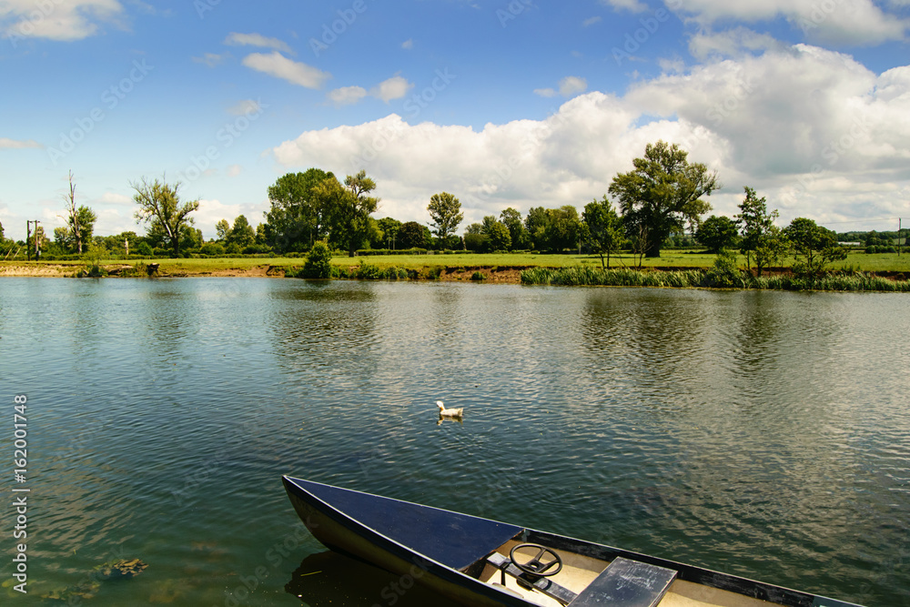 Obraz premium Countryside landscape. River and boat.