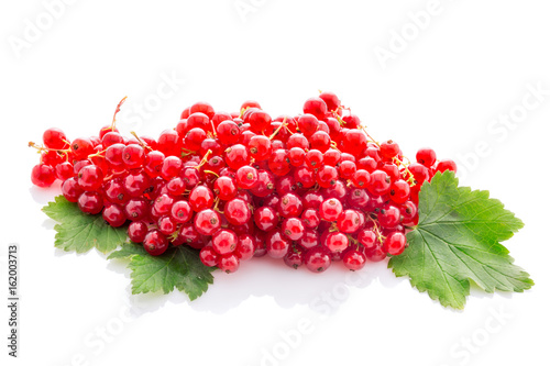 bunch red currant with leaves isolated on white.
