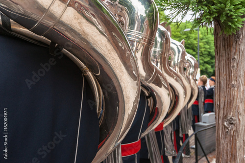 Tuba players seen on the back photo