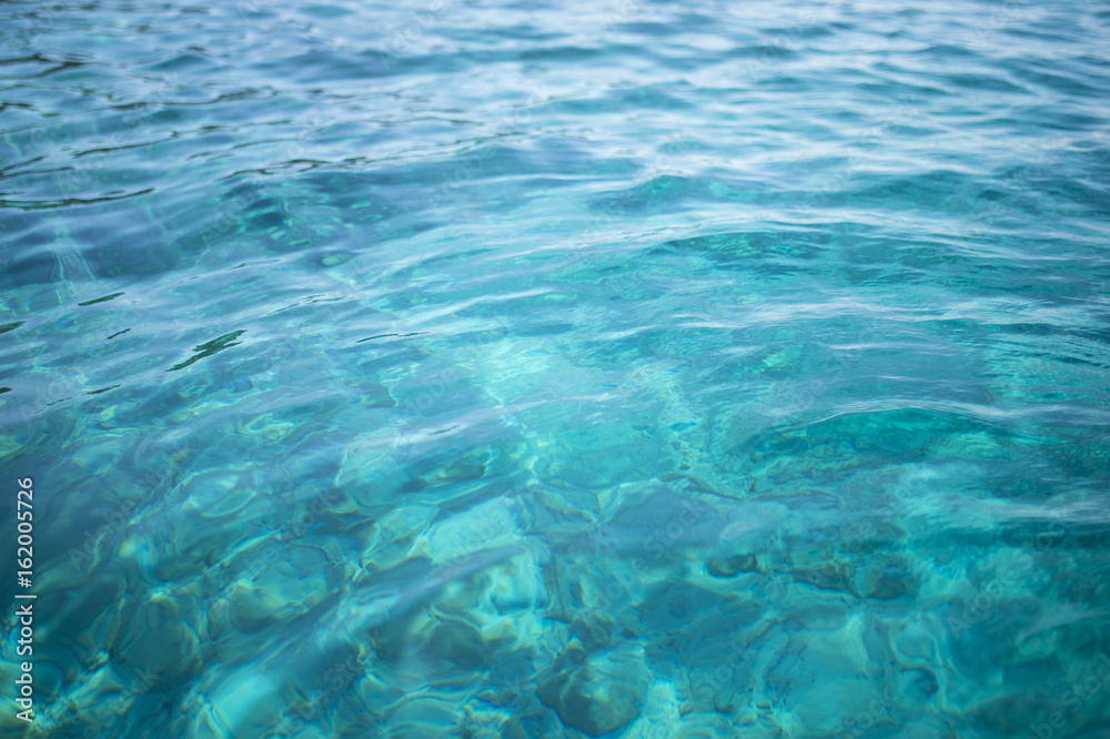 Transparent turquoise sea water, natural background. Emerald Coast, Sardinia, Italt.