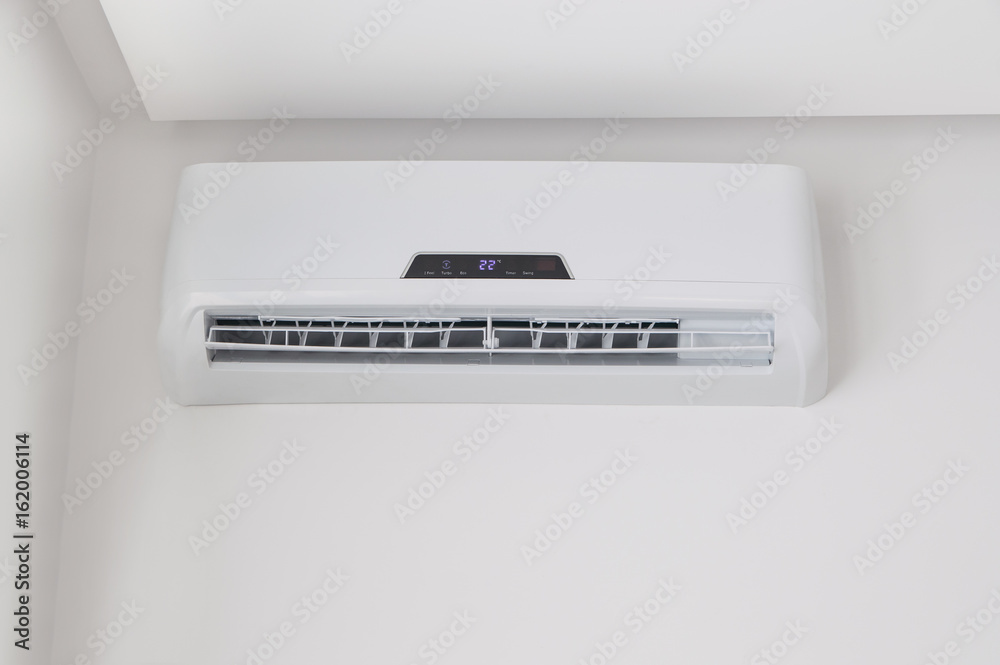White split air conditioner on a white wall. Home interior in a small apartment White split air conditioner on a white wall. Home interior in a small apartment