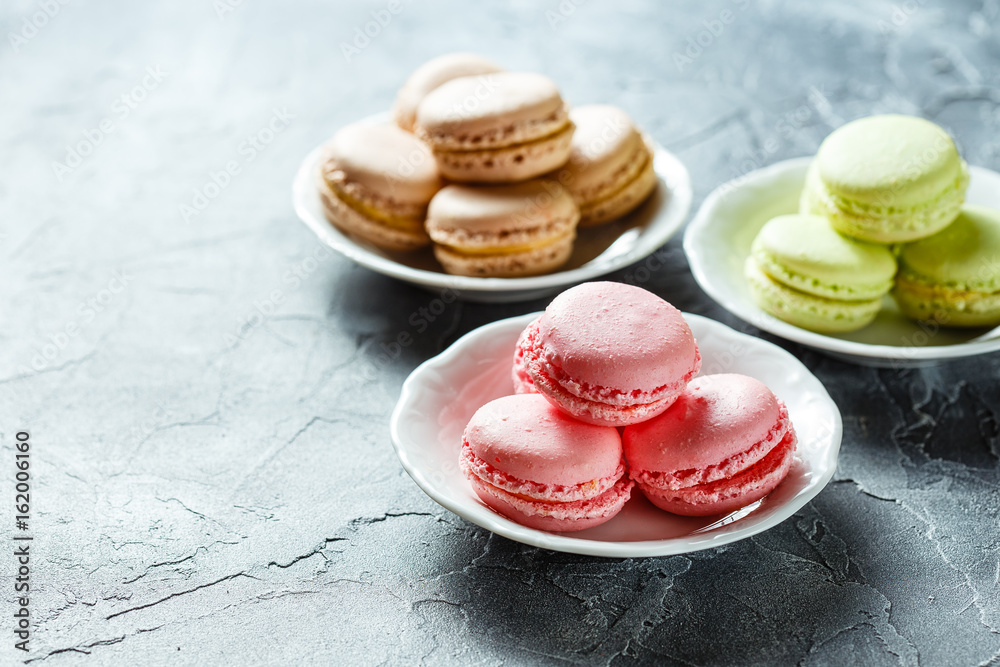 Fototapeta premium Colourful macaroons on the plates