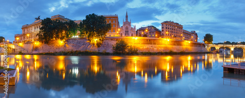 Panoramic view of Tiber riverside with Church of the Sacred Heart of Jesus in Prati and mirror reflection during evening blue hour in Rome, Italy