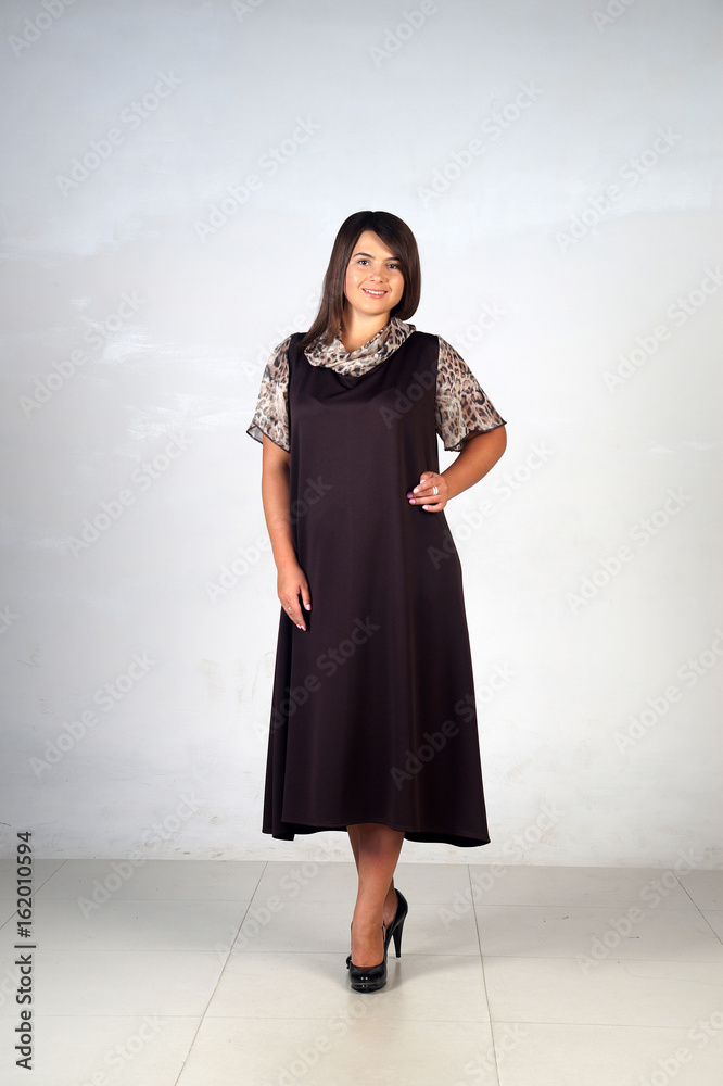 Beautiful young girl posing on a grey background Beautiful young girl posing on a grey background