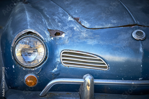 Vintage weathered unrestored blue German classic car with rust hole and tons of character