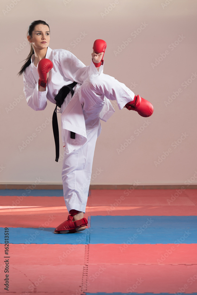 Woman In White Kimono And Black Belt Training Karate