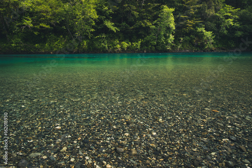 Turquoise river in a forest. photo