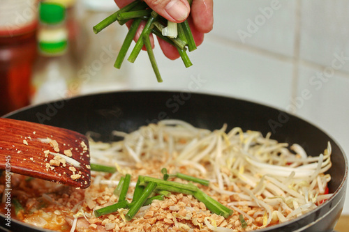 Pad Thai with Crisy wonton and chicken ,bean sprouts topped halvelemon. photo